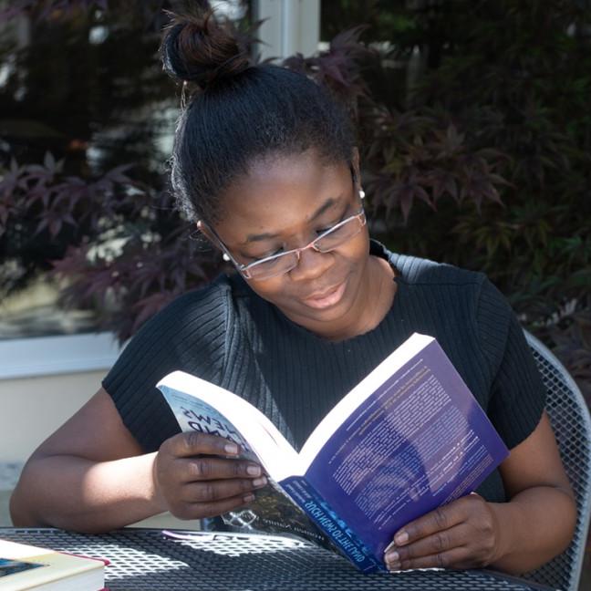 a student sits outside reading